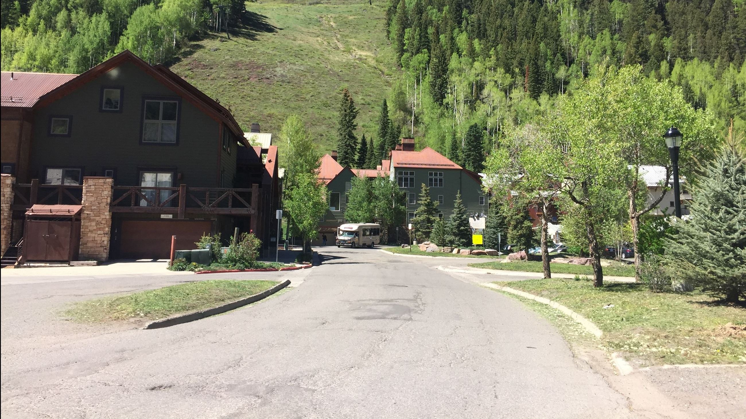 View of Mahoney Street in the summer with a Galloping Goose public transit dropping off a rider.