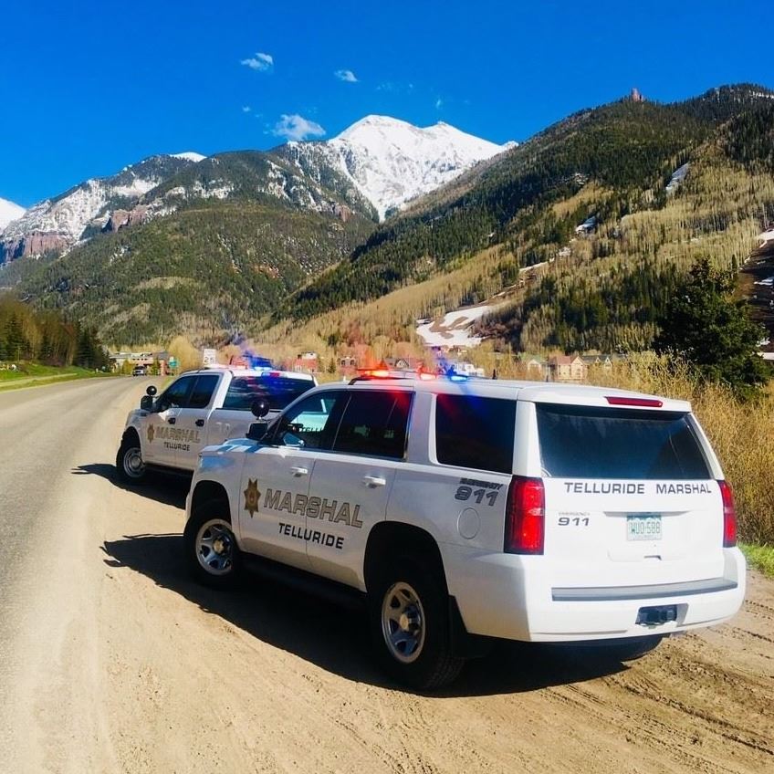 Marshal's Department white vehicle SUV with the siren lights on.